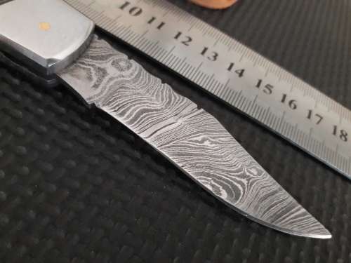 Handmade Damascus steel folding knife with Wooden handle scales.