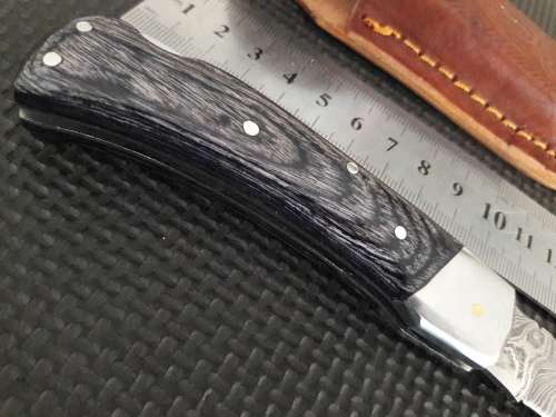 Handmade Damascus steel folding knife with Wooden handle scales.