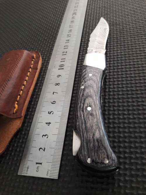 Handmade Damascus steel folding knife with Wooden handle scales.