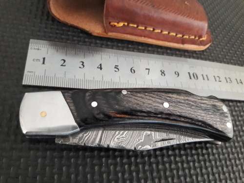 Handmade Damascus steel folding knife with Wooden handle scales.