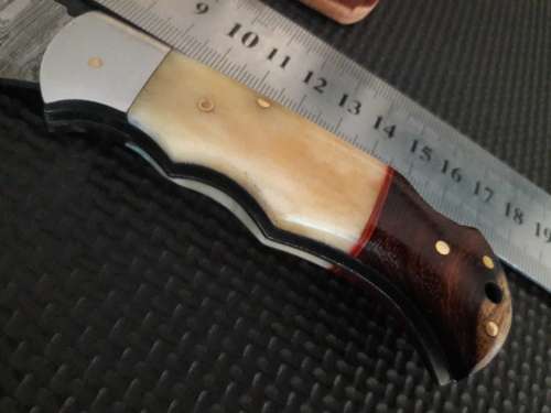 Handmade Damascus steel folding knife with WOOD & CAMEL BONE handle scales.