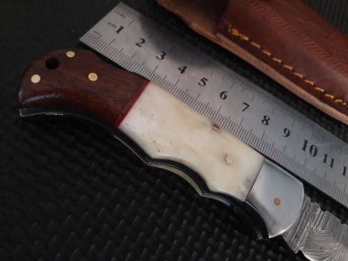 Handmade Damascus steel folding knife with WOOD & CAMEL BONE handle scales.