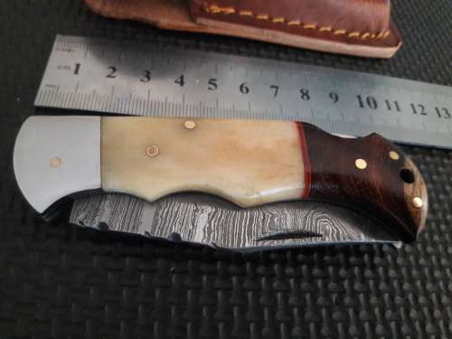 Handmade Damascus steel folding knife with WOOD & CAMEL BONE handle scales.