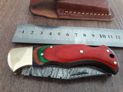 Handmade Damascus steel folding knife with WOODEN handle scales.