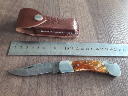 Handmade Damascus steel folding knife with Resin handle scales.