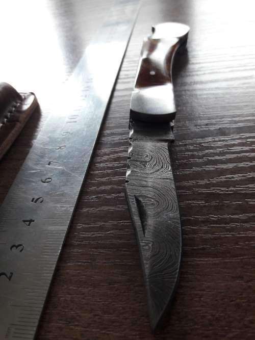Handmade Damascus steel folding knife with Resin handle scales.