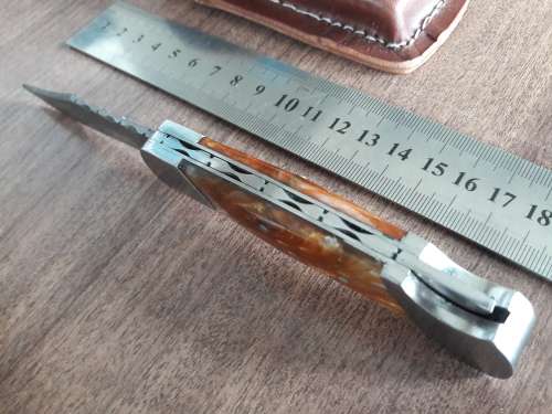 Handmade Damascus steel folding knife with Resin handle scales.