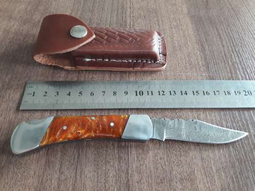 Handmade Damascus steel folding knife with Resin handle scales.