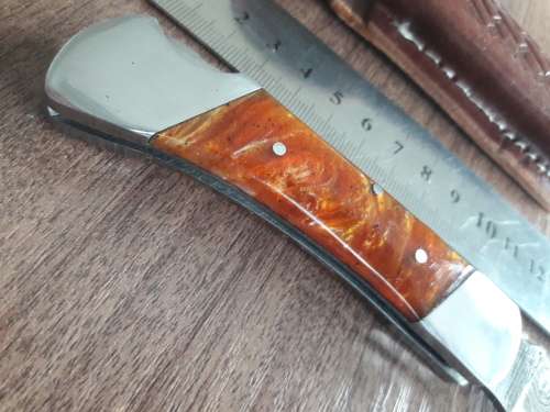 Handmade Damascus steel folding knife with Resin handle scales.
