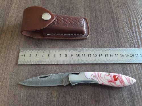 Handmade Damascus steel folding knife with Resin handle scales.