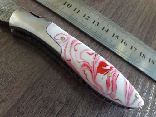 Handmade Damascus steel folding knife with Resin handle scales.