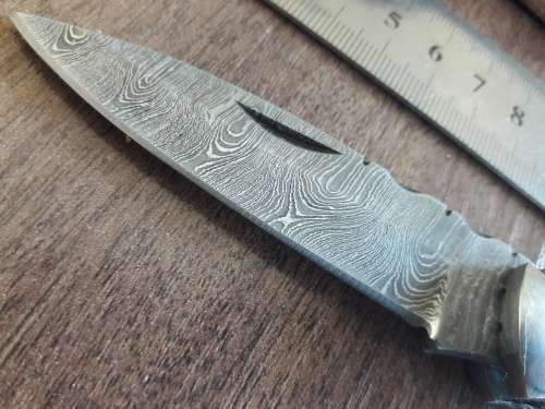 Handmade Damascus steel folding knife with Resin handle scales.