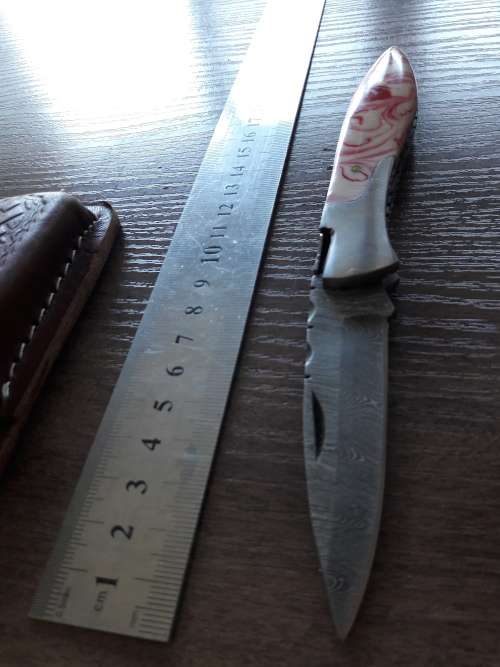 Handmade Damascus steel folding knife with Resin handle scales.