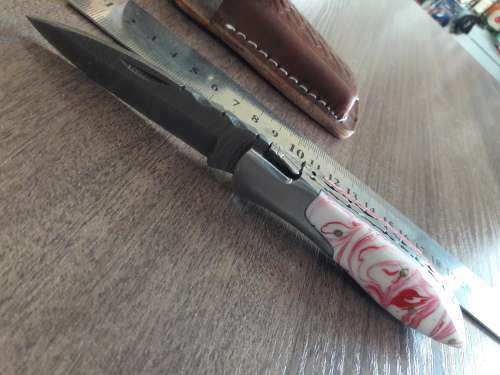 Handmade Damascus steel folding knife with Resin handle scales.