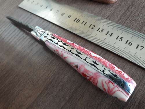 Handmade Damascus steel folding knife with Resin handle scales.