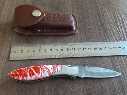 Handmade Damascus steel folding knife with Resin handle scales.