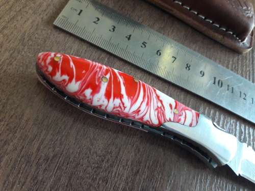 Handmade Damascus steel folding knife with Resin handle scales.