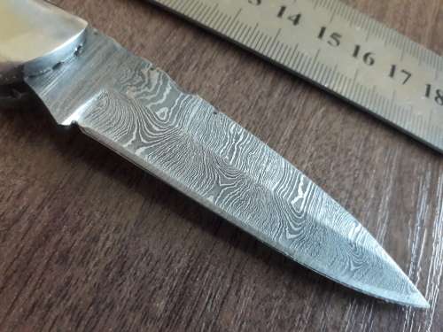 Handmade Damascus steel folding knife with Resin handle scales.
