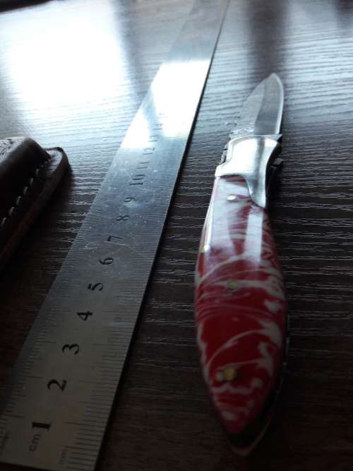 Handmade Damascus steel folding knife with Resin handle scales.