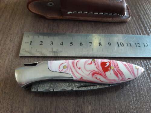 Handmade Damascus steel folding knife with Resin handle scales.