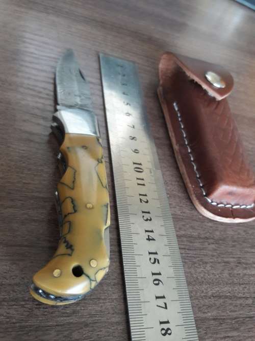 Handmade Damascus steel folding knife with Resin handle scales.