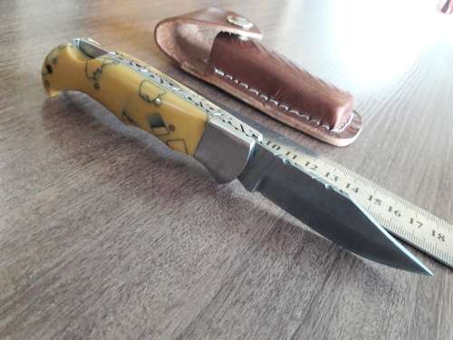 Handmade Damascus steel folding knife with Resin handle scales.