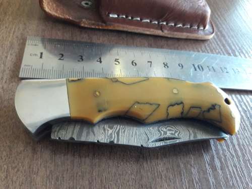 Handmade Damascus steel folding knife with Resin handle scales.