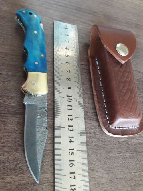 Handmade Damascus steel folding knife with Camel Bone handle scales.
