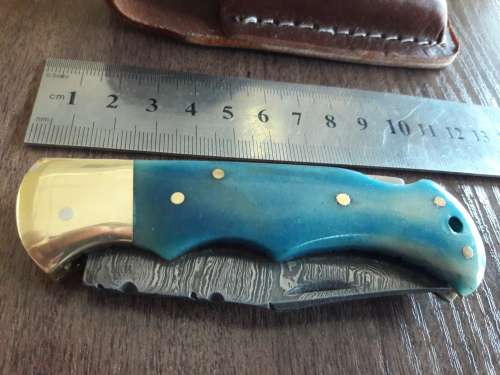 Handmade Damascus steel folding knife with Camel Bone handle scales.