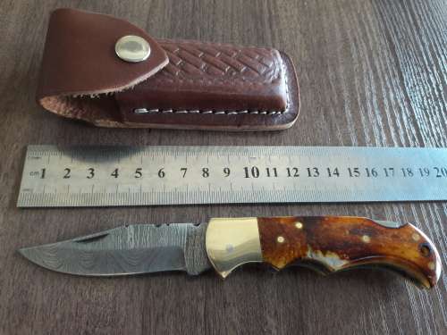 Handmade Damascus steel folding knife with Burnt Camel Bone handle scales.
