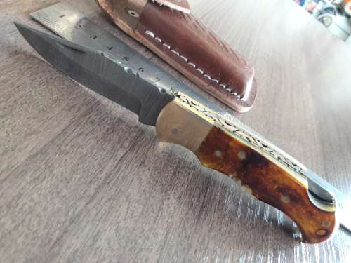 Handmade Damascus steel folding knife with Burnt Camel Bone handle scales.