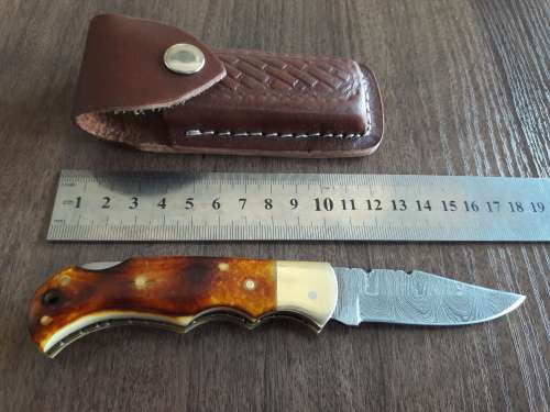 Handmade Damascus steel folding knife with Burnt Camel Bone handle scales.