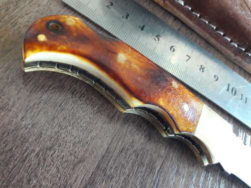 Handmade Damascus steel folding knife with Burnt Camel Bone handle scales.