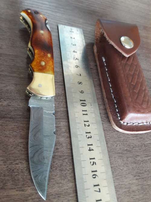 Handmade Damascus steel folding knife with Burnt Camel Bone handle scales.