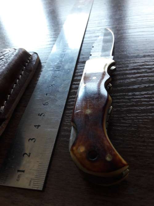 Handmade Damascus steel folding knife with Burnt Camel Bone handle scales.