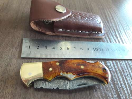 Handmade Damascus steel folding knife with Burnt Camel Bone handle scales.