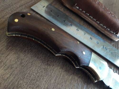 Handmade Damascus steel folding knife with Wooden handle scales.