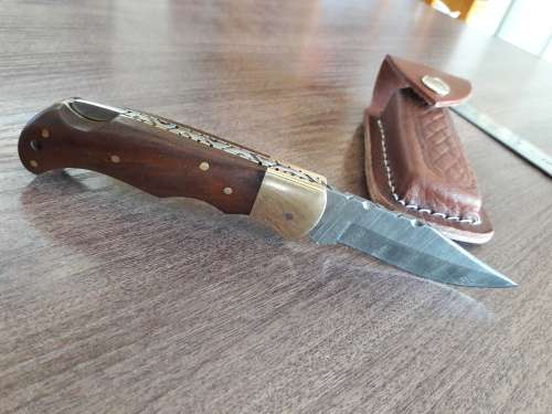 Handmade Damascus steel folding knife with Wooden handle scales.