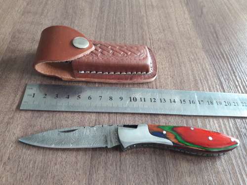 Handmade Damascus steel folding knife with Wooden handle scales.