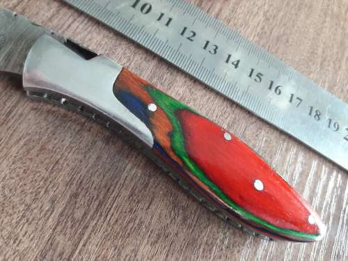 Handmade Damascus steel folding knife with Wooden handle scales.