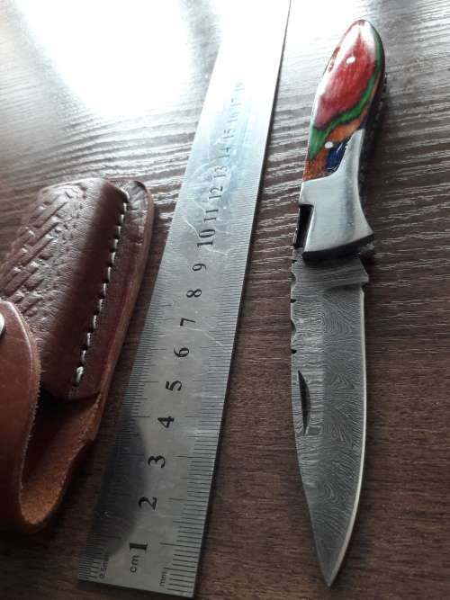 Handmade Damascus steel folding knife with Wooden handle scales.