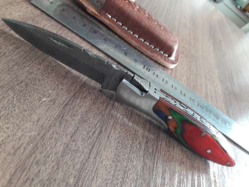 Handmade Damascus steel folding knife with Wooden handle scales.