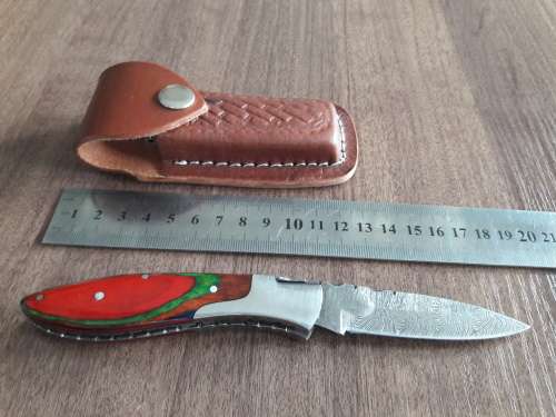 Handmade Damascus steel folding knife with Wooden handle scales.