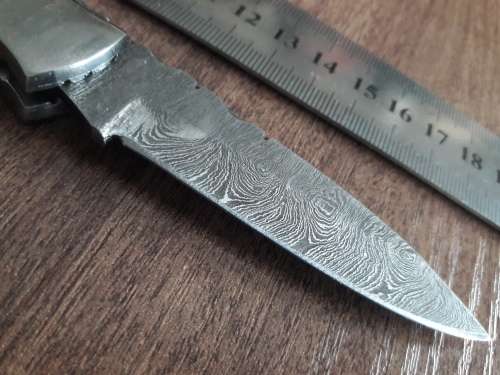 Handmade Damascus steel folding knife with Wooden handle scales.