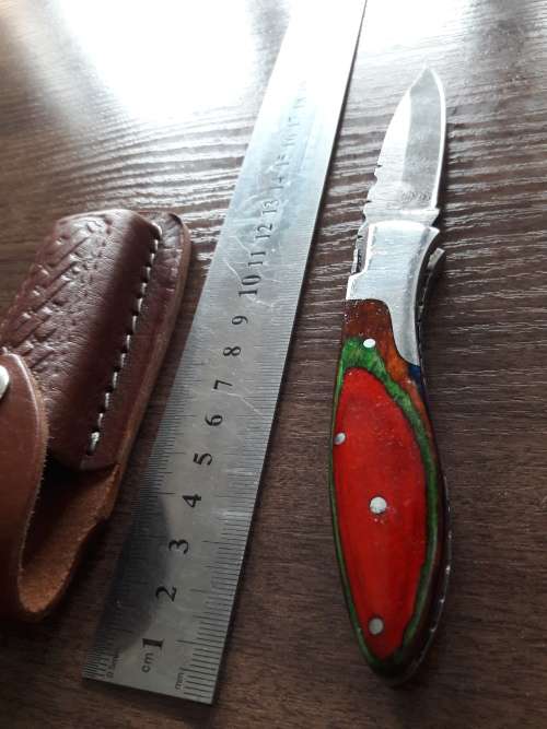 Handmade Damascus steel folding knife with Wooden handle scales.