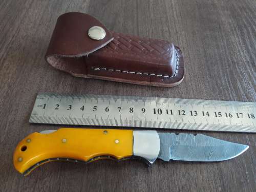 Handmade Damascus steel folding knife with Resin handle scales.