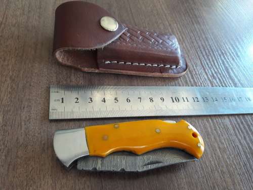 Handmade Damascus steel folding knife with Resin handle scales.
