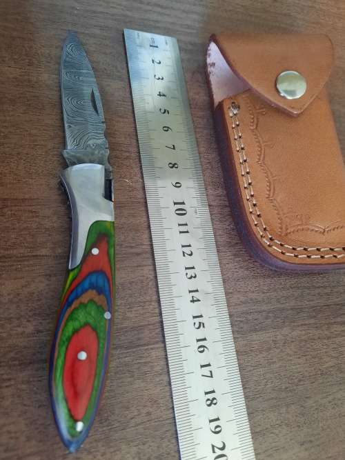 Handmade Damascus steel folding knife with Wooden handle scales.