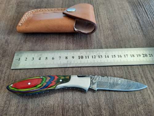 Handmade Damascus steel folding knife with Wooden handle scales.