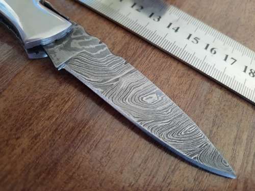 Handmade Damascus steel folding knife with Wooden handle scales.